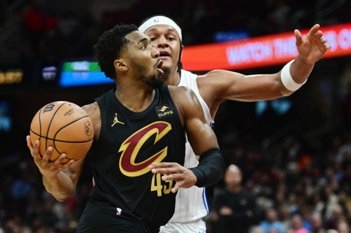 Dec 6, 2023; Cleveland, Ohio, USA; Cleveland Cavaliers guard Donovan Mitchell (45) drives to the basket against Orlando Magic forward Paolo Banchero (5) during the second half at Rocket Mortgage FieldHouse.